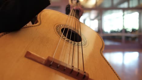 close up of mariachi charro playing guitar