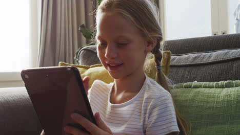 little caucasian girl using digital tablet