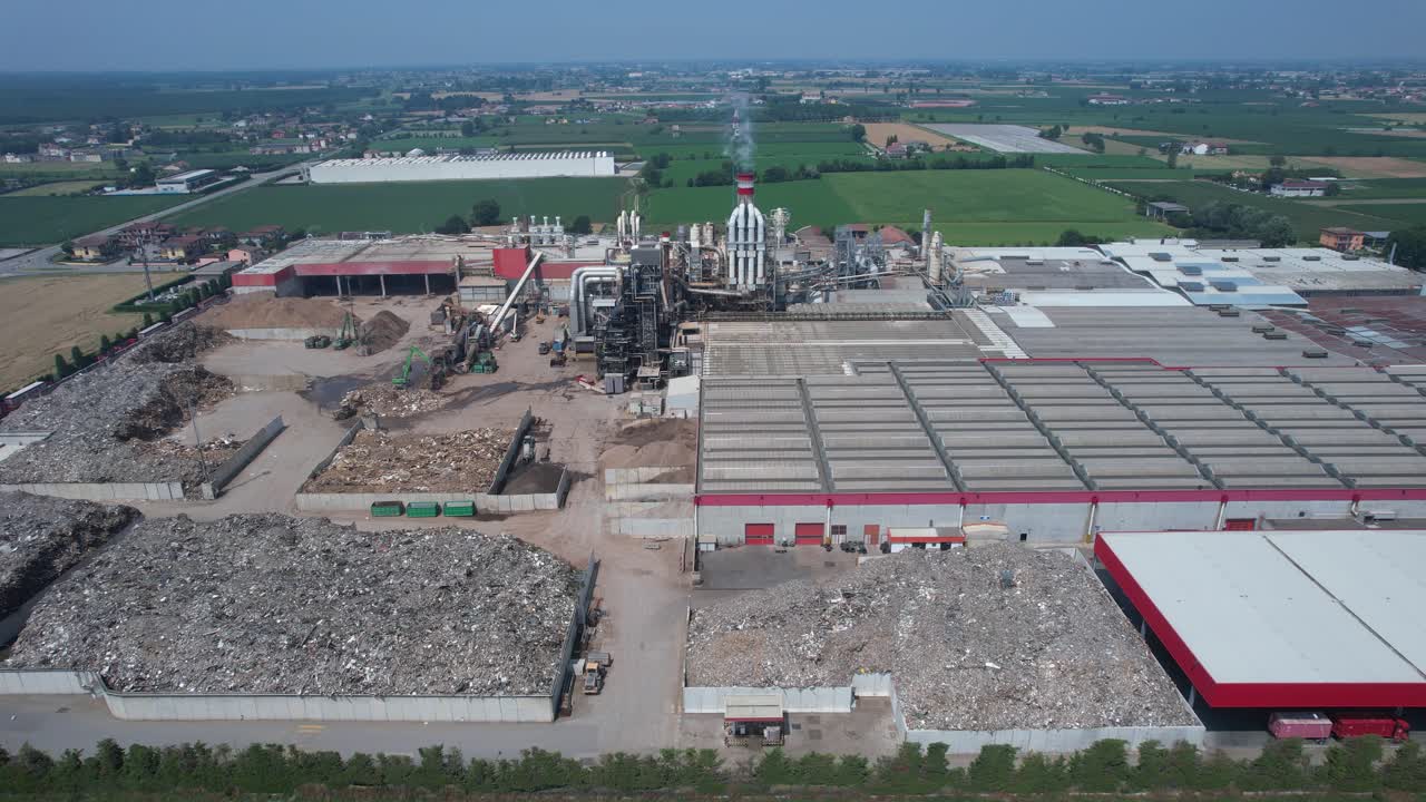 drone view of an integrated cement manufacturing plant showing rotary kiln line, preheater tower, clinker cooling system, raw material storage yards and heavy industrial processing infrastructure