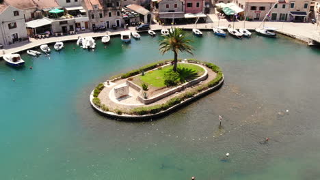 aerial drone shot of a small palm tree island in vrboska, on the island of hvar, croatia