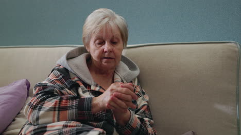 elderly woman sitting on a couch