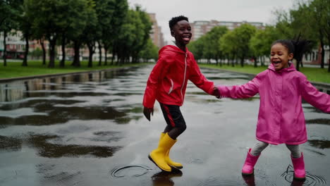 happy children splashing in puddles