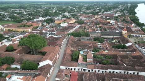 drone fly above historical city colonial architecture in colombia santa cruz de mompox with river magdalena