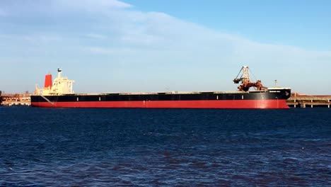 view of a hopper dredge collecting sand from the bottom of the ocean