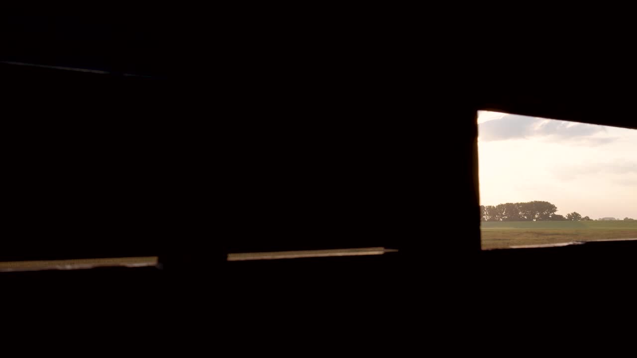 Observing a Marsh Landscape from a Bird Blind at Sunrise or Sunset