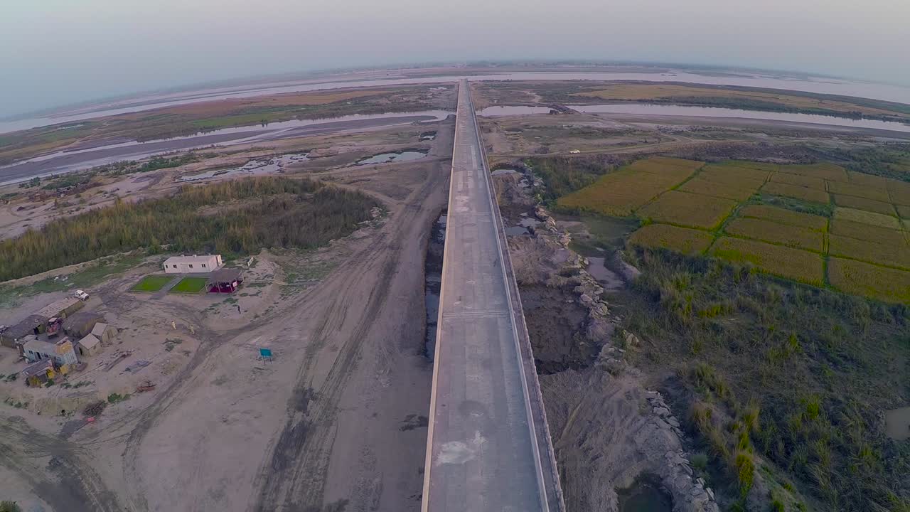 vista aérea del puente bajo construcción, granjas en el río