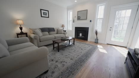 Elegant-Transitional-House-Interior---Light-coloured-Sofas-And-Printed-Grey-Carpet-On-Classic-Light-Wood-Floor---zoom-out-shot