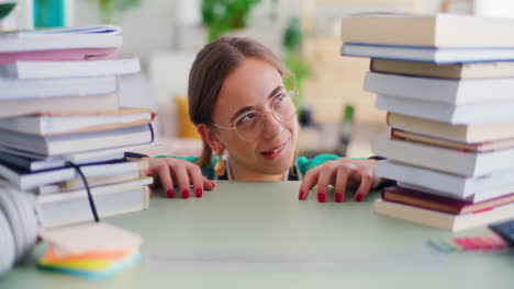 portrait of a curious student with a stack of books to read