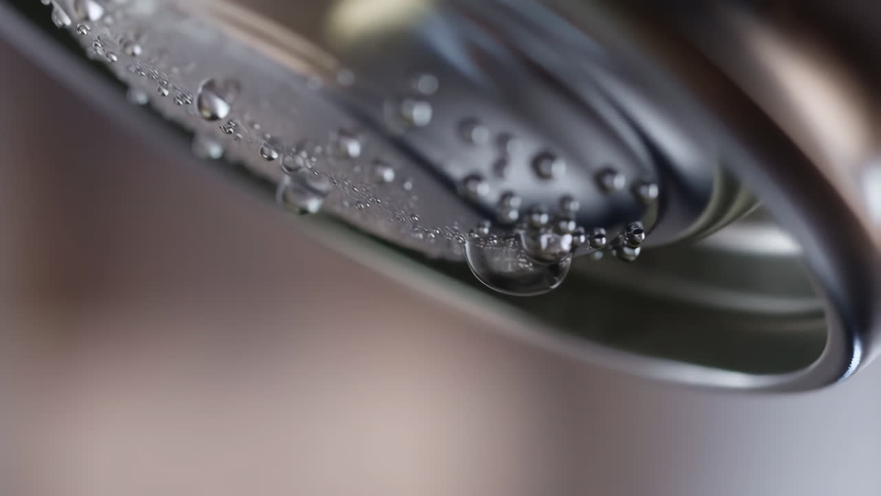 Close-up of Water Droplets and Bubbles on a Metallic Surface