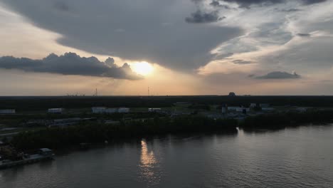 Aerial-reverse-reveal-of-sunset-over-Mississippi-River-in-New-Orleans