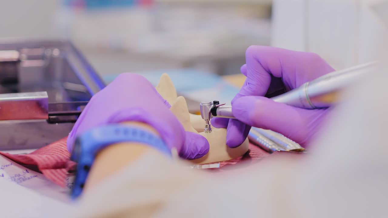 Close Up of Dental Student Practicing Jaw Drilling Indoors with Calm Precision