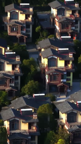 vertical drone shot in front of similar neighborhood homes, sunrise in china