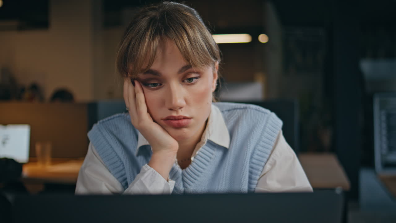 Tired entrepreneur feeling bored working laptop indoors closeup. Fatigued girl