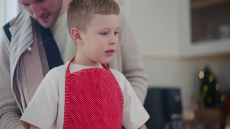 dad and son start making christmas cake together