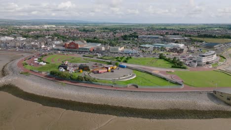 seaside town headland and town visible. proposed eden project construction site. summer. marine road central, morecambe, lancashire, uk