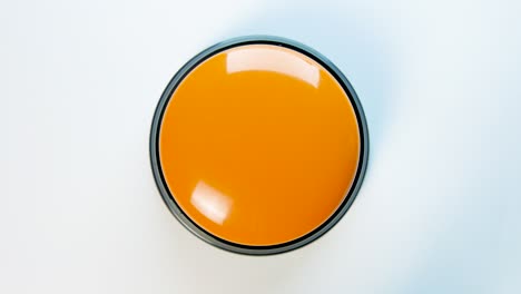 young woman pushing orange button with a finger and palm of her hand. press a round glossy button, top view. activation, launching something. turn on and off.