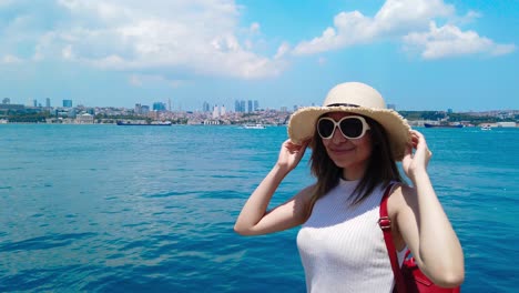 slow motion:beautiful girl stands in front of bosphorus,a popular destination in istanbul,turkey