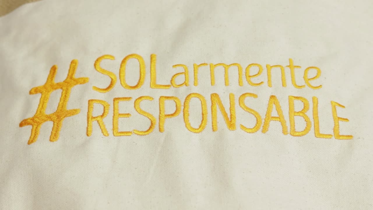 Phrase embroidered in yellow thread on a blanket