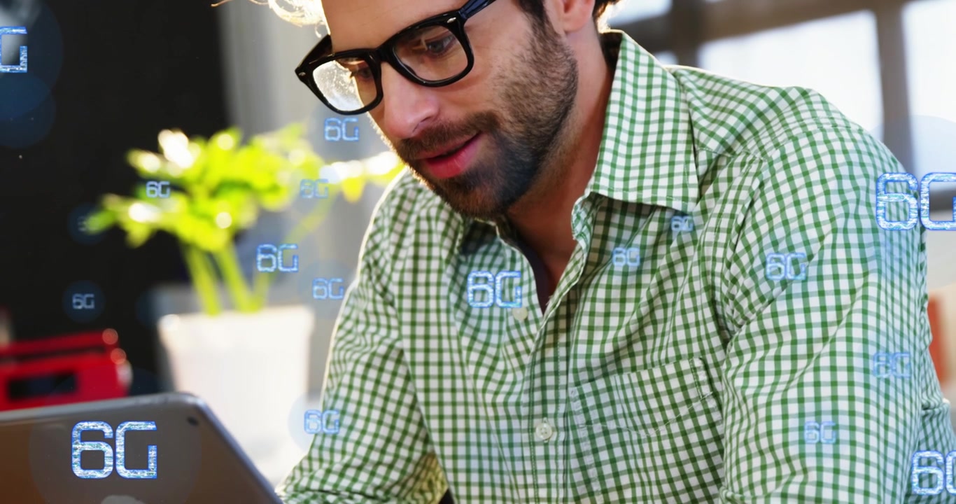 Animation of multiple 6g text over smiling caucasian man watching video on digital tablet in cafes