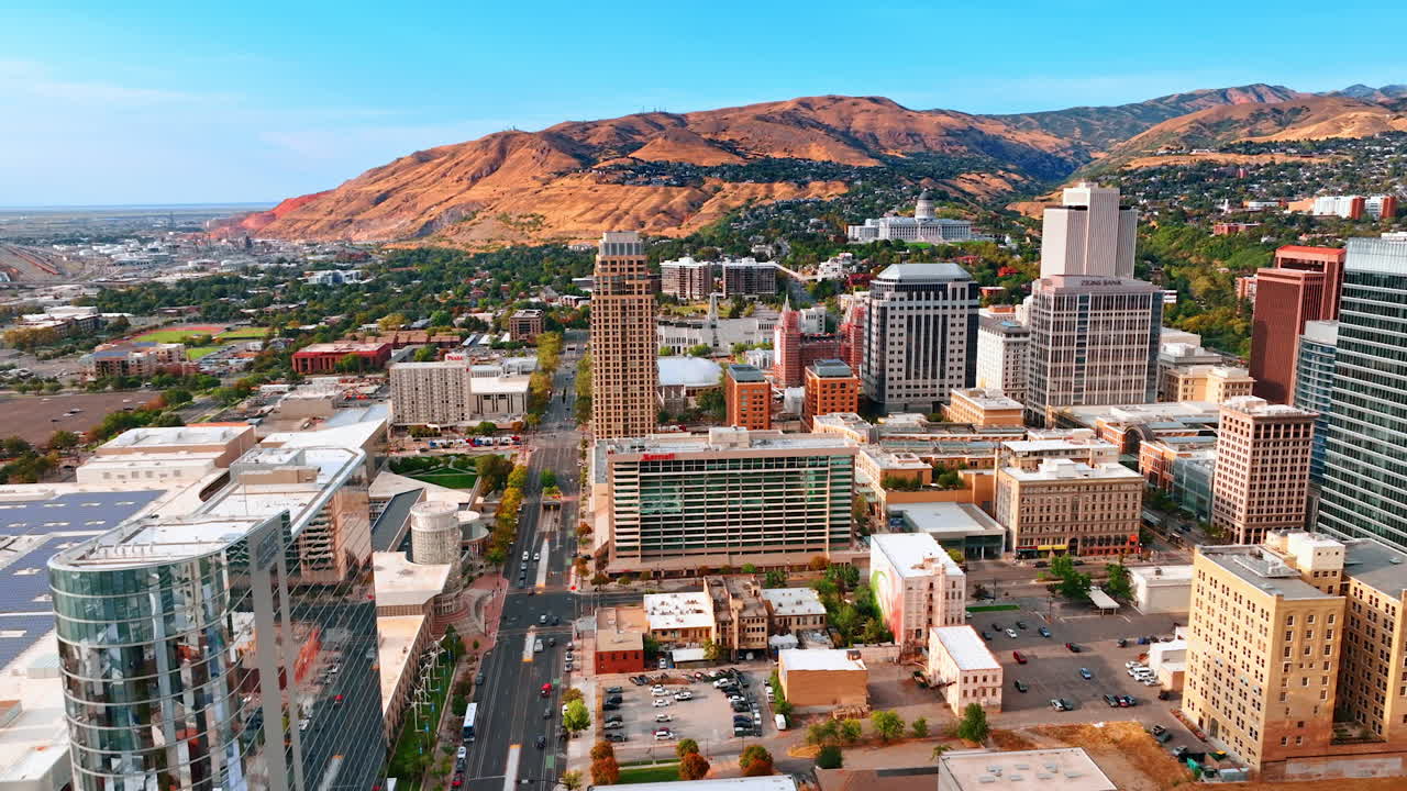 Salt Lake City, USA, 14 August 2025: Beautiful scenery of modern Salt Lake City, Utah, USA. Drone flight over the wide street approaching the bare mountains