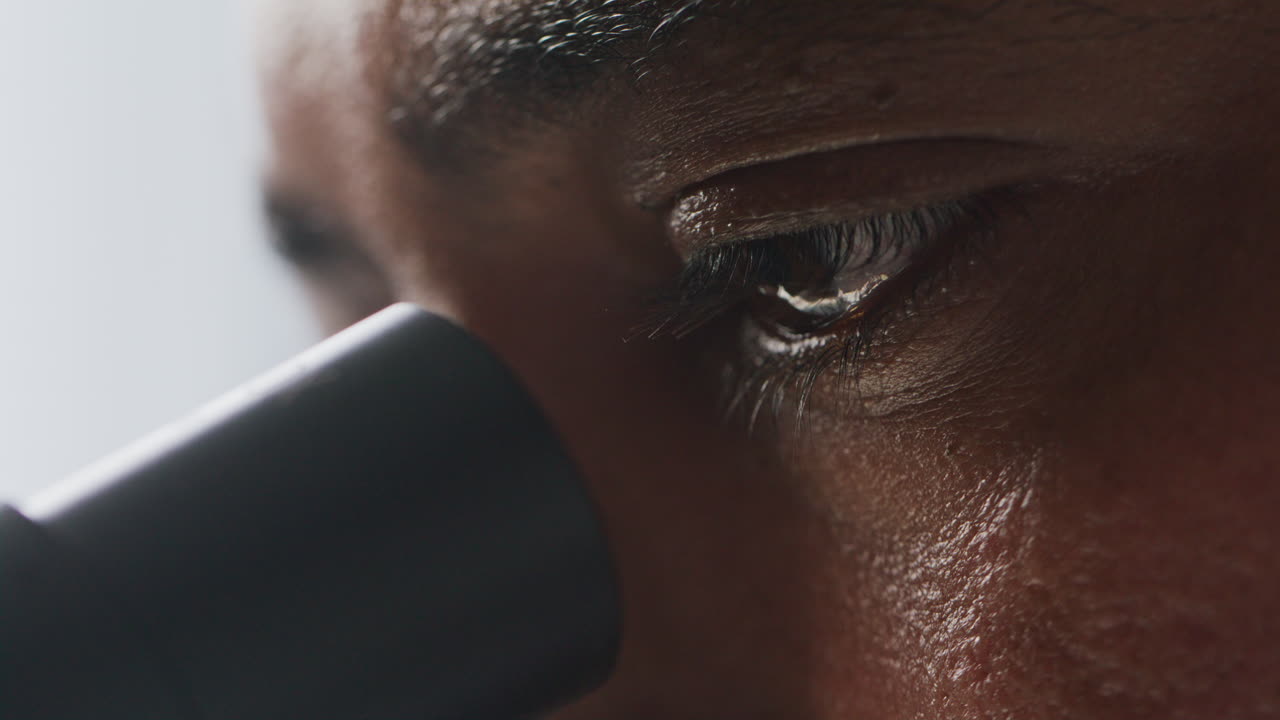 Observing Sample Through Microscope with Intense Concentration