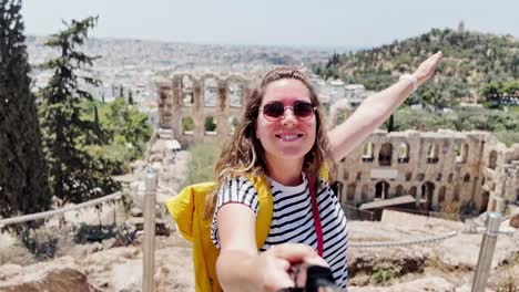 excited tourist showing view of an ancient theatre, athens, greece