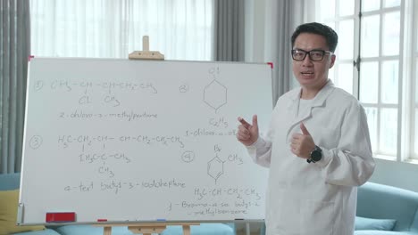 asian male teacher with glasses teaching chemist at home