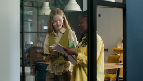 two businesswomen collaborating in a modern office