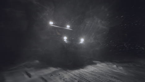 half-track driving in the night in jotunheimen in norway. the half-track has skies in front. its night and the snow are falling. filmed on a gimbal in 4k. this is a slow-motion clip.