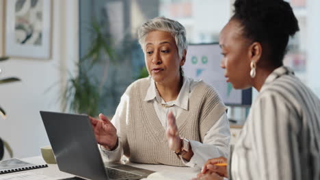 two businesswomen collaborating in an office