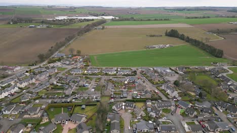 Serene-Countryside-Houses-Nestled-in-Peaceful-Surroundings,-Aerial-Scotland