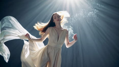 ethereal woman floating in light and water