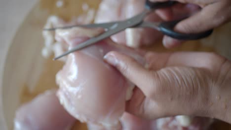 cutting chicken with scissors