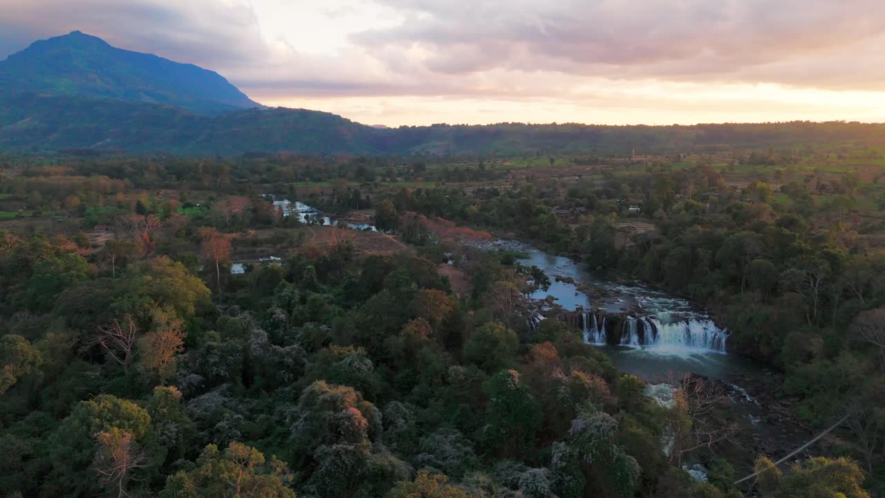 Aerial of river winding through green valleys in Bolaven Plateau in southern Laos Champasak Province