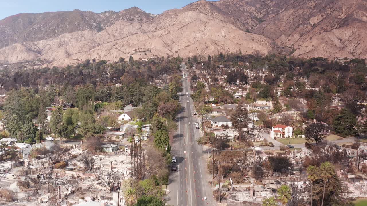 Low aerial shot flying north over Lake Street within the Eaton Fire burn zone in Altadena, California. 4K