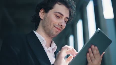 young professional man using a digital tablet outdoors