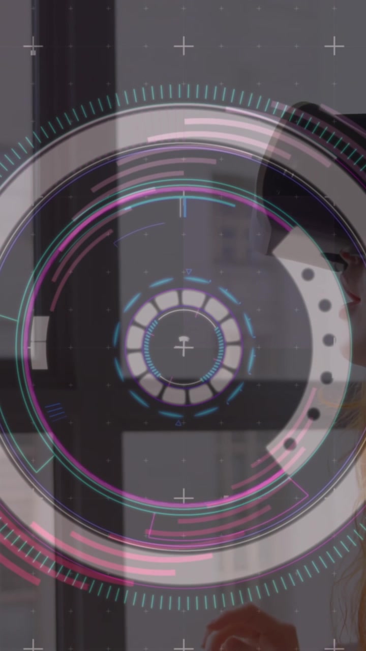 Animation of spinning shapes over woman using vr headset