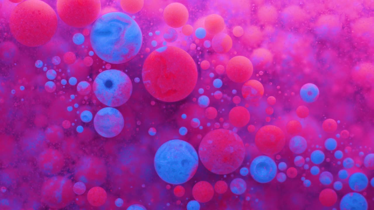Slow Motion Bright Neon Color Bubbles Oil Beautiful Fluorescent Paint Sparkling Color Moving Multicolor Close up. Acrylic Neon Paint. Fantastic Surface. Abstract Colorful Transformation Gravitation.