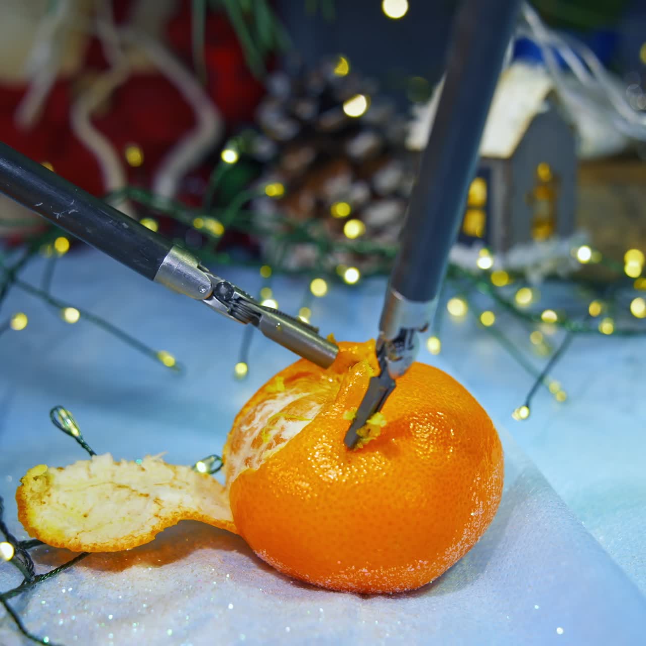 Human like robot peels tangerine while preparing to the Christmas. Cropped view. Computers concept