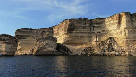 fpv panning of bonifacio corse town built on high cliff seen from sailing boat along corsica coast in france