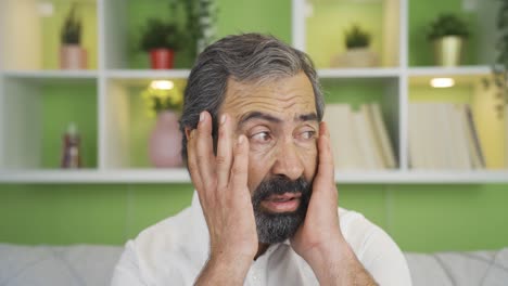 Close-up-mature-man-looking-at-camera-with-fear-and-panic.