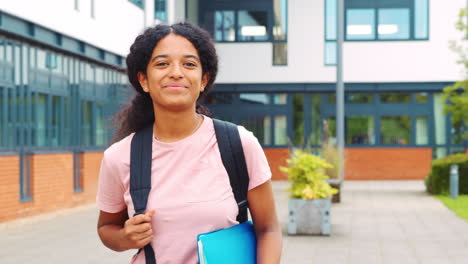 portrait of female student standing outside college building