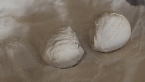 dough being rolled in flour during the making of naan bread.
