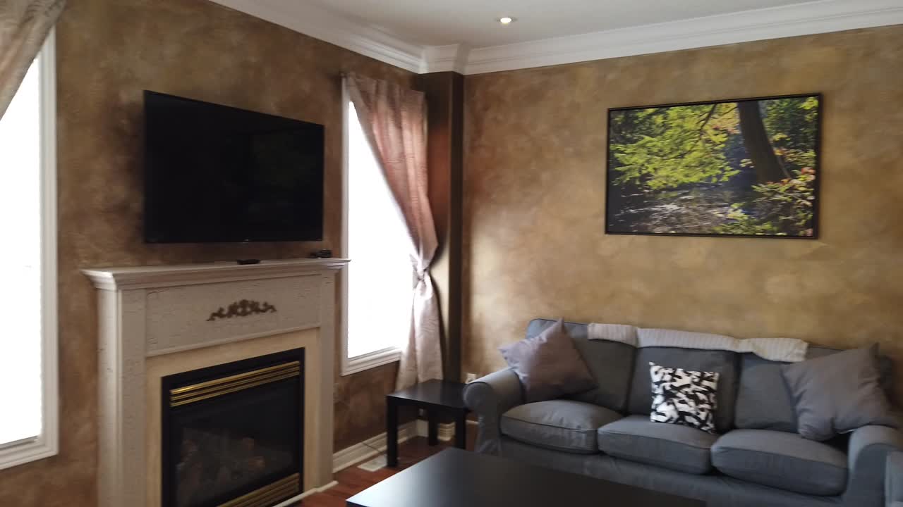 Cozy Living Room with Fireplace and Landscape Painting