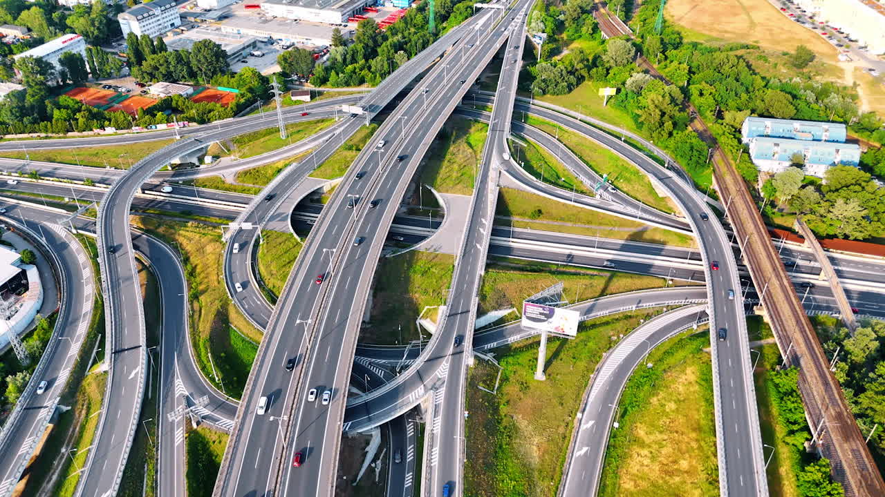 Complex highway interchange in Europe. Aerial view of a busy highway interchange in Europe showcasing multiple lanes and traffic patterns during daytime