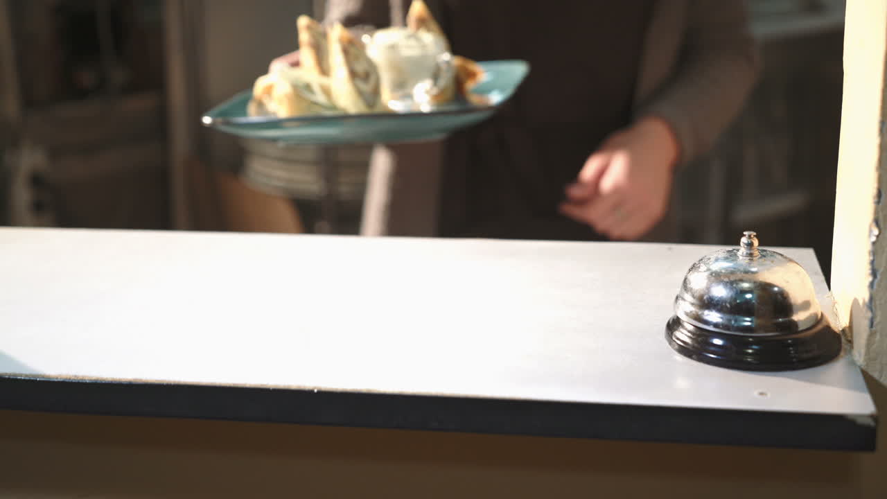 Professional chef at the restaurant serves pancakes with meat stuffing.