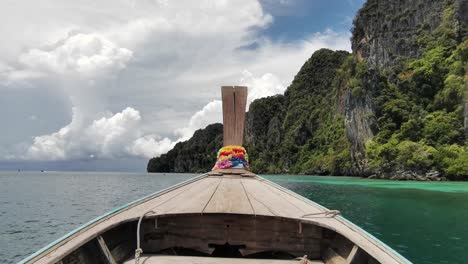 longtail boat journey with a bow view, revealing thailand's enchanting rocky cliffs near ko phi phi island