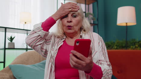 sad senior granfather use mobile smartphone loses becoming surprised sudden bad lottery results news