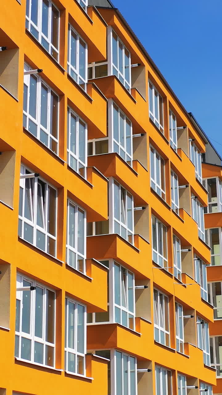 Multi-storey buildings in residential area. New modern apartment building in modern residential complex. Vertical video