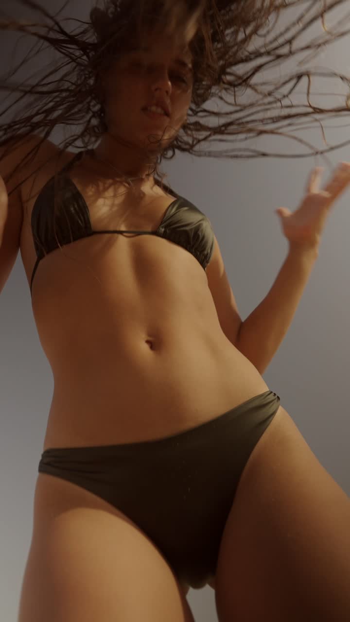 Woman in bikini shaking her hair